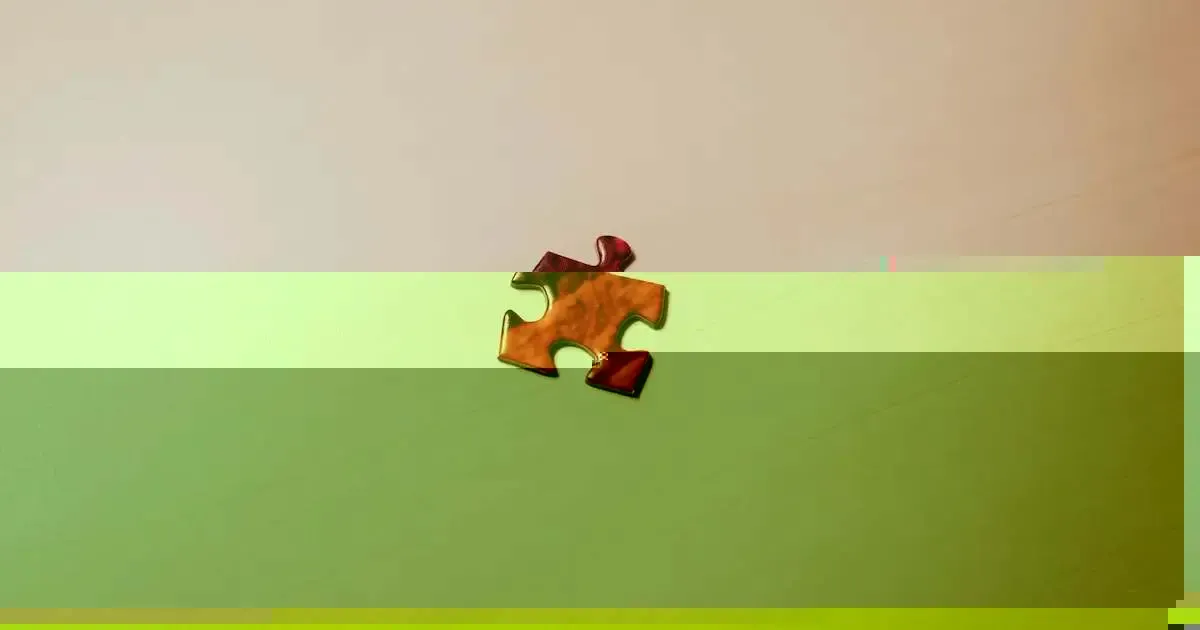a single red jigsaw puzzle piece sitting on a table